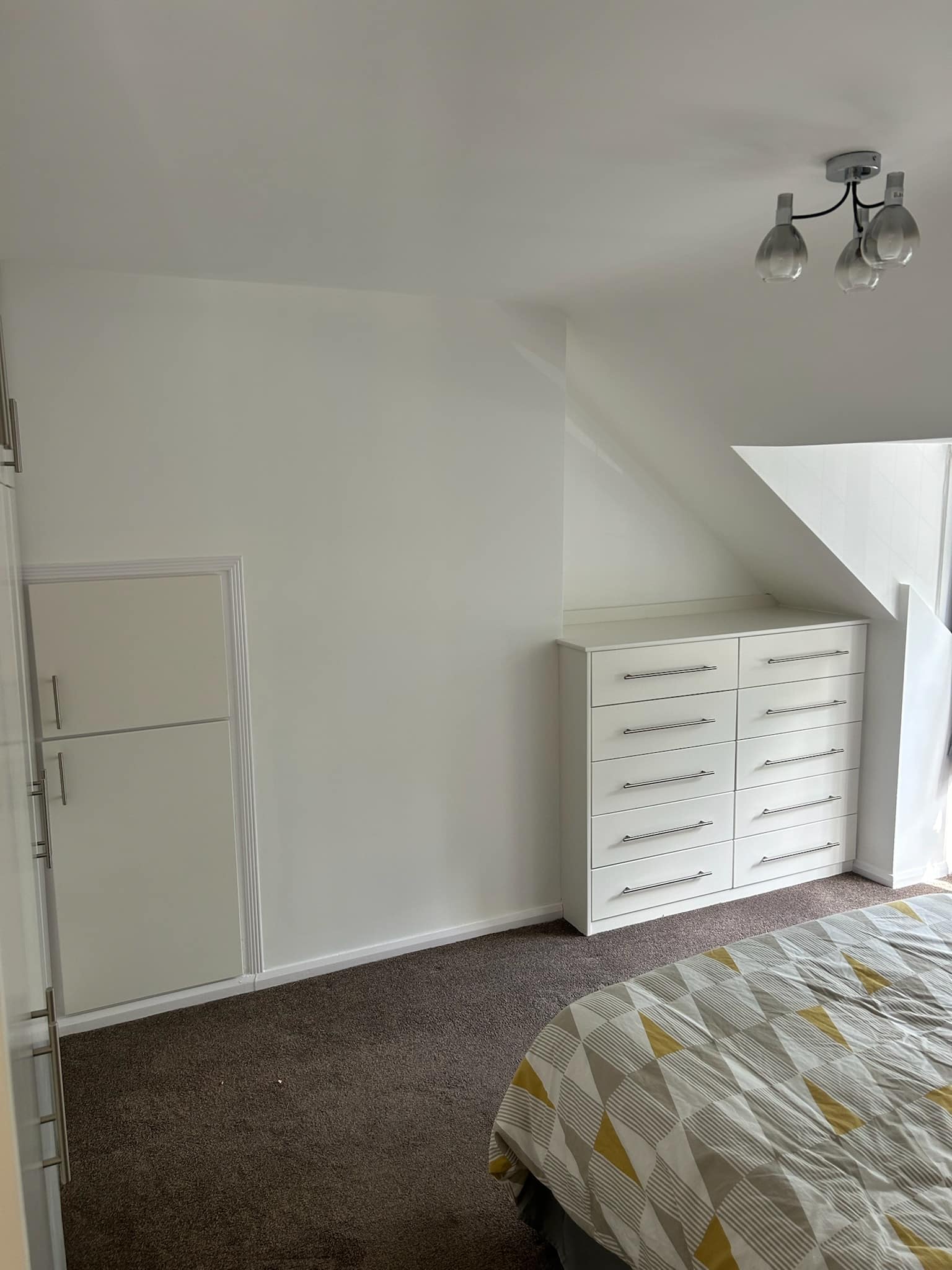 Bespoke cream coloured storage shelf installed by Nick Turner Joinery